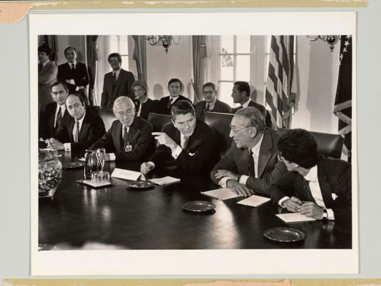 photograph of President Reagan seated at conference table, before treatment