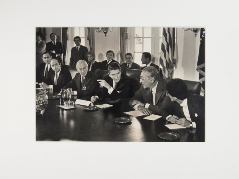 photograph of President Reagan seated at conference table, after rehousing